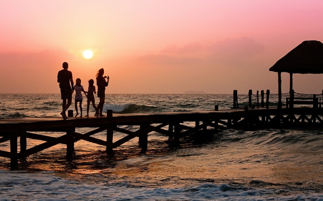 family on pier at sunset